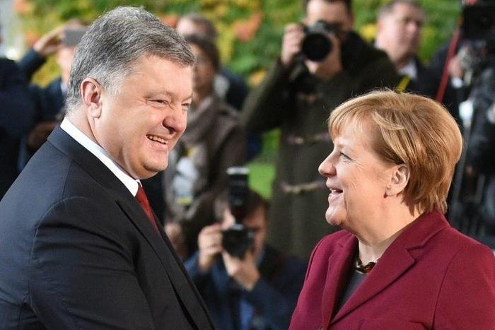 German Chancellor Angela Merkel (R) welcomes Ukrainian President Petro Poroshenko upon arrival at the chancellery on October 19, 2016 in Berlin