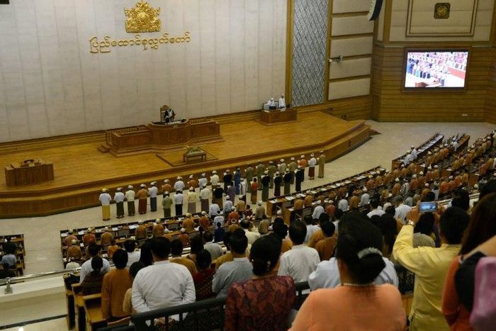 Myanmar ministers are sworn into office by Upper House Speaker Mahn Win Khine (on podium) during a ceremony at the parliament in Naypyidaw on March 30, 2016