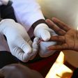 A doctor draws blood from a man to check for HIV/AIDS at a mobile testing unit in Ndeeba, a suburb in Uganda's capital Kampala May 16, 2014.