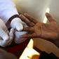 A doctor draws blood from a man to check for HIV/AIDS at a mobile testing unit in Ndeeba, a suburb in Uganda's capital Kampala May 16, 2014.