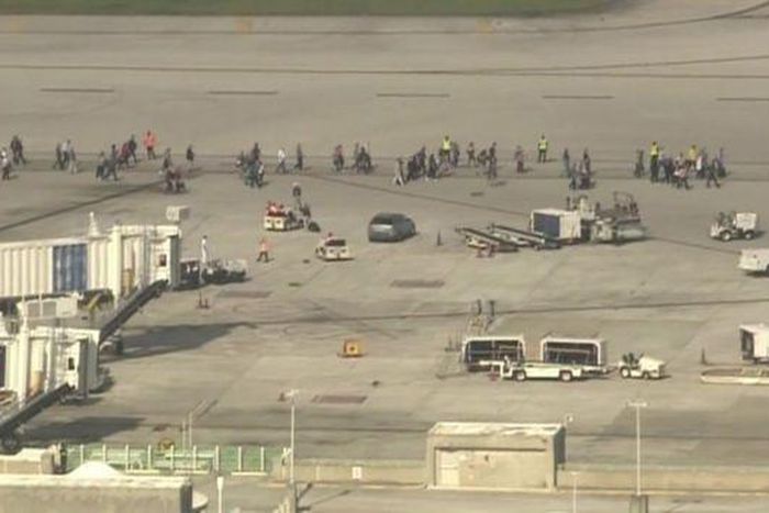 Hundreds of people have been forced to wait on the airport tarmac for police to clear the terminal