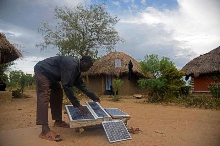 Robert Otala checks on solar panels that he uses for his home in Soroti District about 300 kilometres northeast of the capital Kampala
