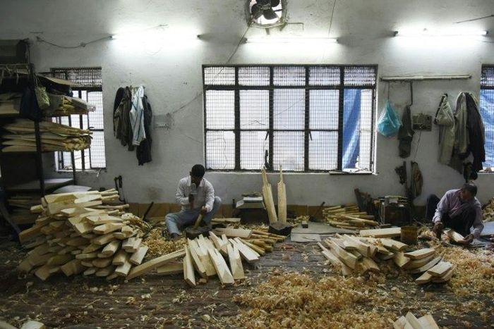 An Indian craftsman works on unfinished cricket bats in a factory in Meerut, some 70kms north-east of New Delhi