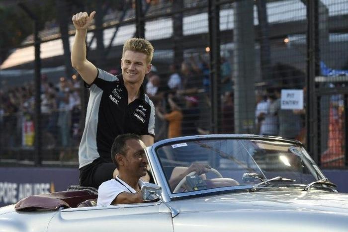 Sahara Force India F1 Team's German driver Nico Hulkenberg gives a thumbs up to the crowd before the Formula One Singapore Grand Prix on September 18, 2016
