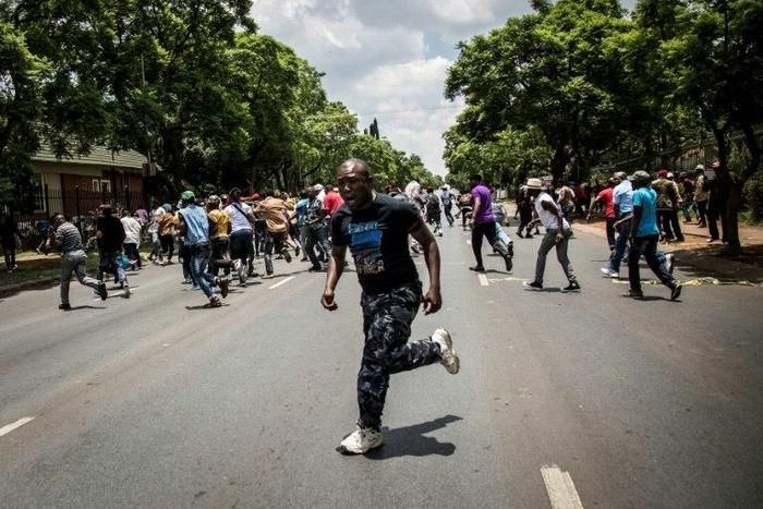 Police fire rubber bullets at demonstrators protesting outside the Democratic Republic of the Congo's Embassy in defiance of their President, Joseph Kabila on December 20, 2016 in Pretoria