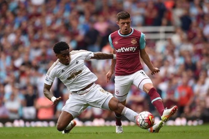 West Ham's Aaron Cresswell in action with Swansea City's Leroy Fer