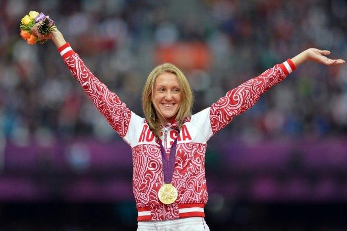 Russian steeplechase athlete Yuliya Zaripova celebrates her gold medal on the podium after the women's 3000m steeplechase at the London 2012 Olympic Games on August 7, 2012