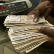 A currency dealer counts Kenya shillings at a money exchange counter in Nairobi  in a file photo.  REUTERS/Antony Njuguna