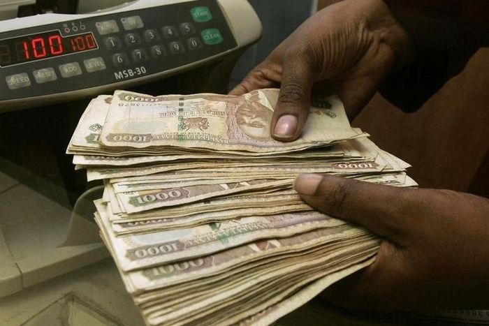 A currency dealer counts Kenya shillings at a money exchange counter in Nairobi  in a file photo.  REUTERS/Antony Njuguna