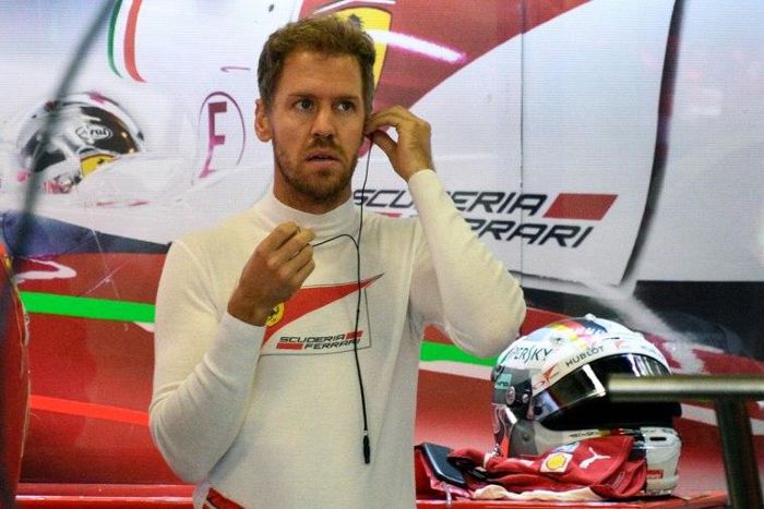 Scuderia Ferrari's German driver Sebastian Vettel, gets prepared at the pits area during the Formula One Mexico Grand Prix practice session at the Hermanos Rodriguez circuit, in Mexico City on October 29, 2016