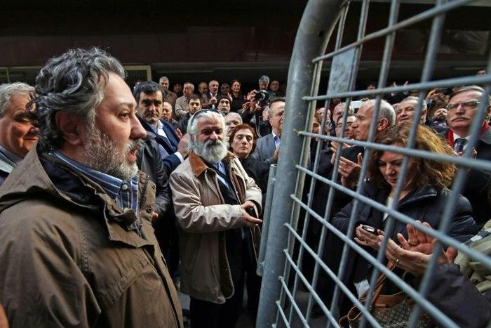 Cumhuriyet Daily Newspaper's editor in chief Murat Sabuncu was detained and police were hunting for executive board chairman Akin Atalay