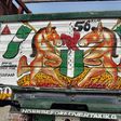 A drawing of the Nigerian coat of arms on a truck