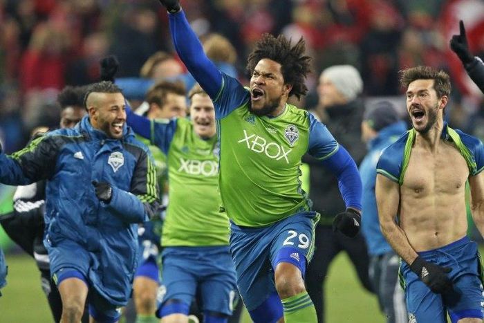 Roman Torres (C) of the Seattle Sounders celebrates with teammates his championship winning goal against the Toronto FC during the 2016 MLS Cup Final match, at BMO Field in Toronto, on December 10