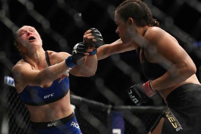 Amanda Nunes (R) barely broke a sweat against a helpless Ronda Rousey, winning their UFC women's bantamweight championship bout with a TKO in under a minute