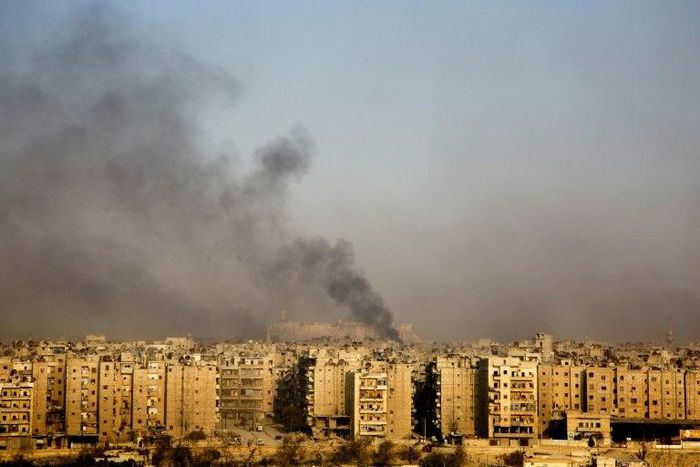 Smoke billows from the former rebel-held district of Bustan al-Qasr in Aleppo, on December 12, 2016
