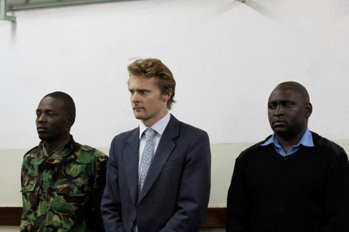 British national Jack Alexander Wolf Marrian (C), flanked by police officers, appears in court in Nairobi on August 8, 2016, where he faces charges of trafficking 100 kilos of cocaine from Brazil to the port of Mombasa