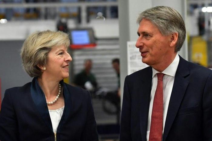 British Prime Minister Theresa May (left) speaks with Chancellor of the Exchequer Philip Hammond during a visit to the Jaguar Land Rover factory in Solihull, on September 1, 2016