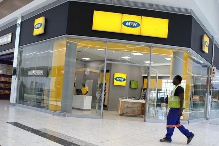 A worker walks past an outlet of South Africa's MTN Group in Johannesburg, South Africa