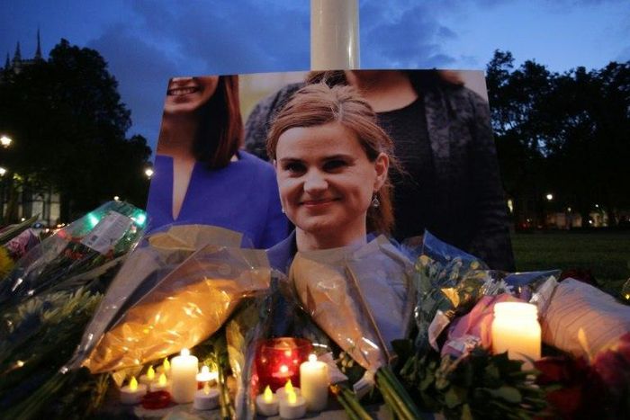 Floral tributes and candles are placed by a picture of slain Labour MP Jo Cox at a vigil in Parliament square in London on June 16, 2016