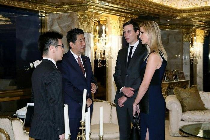 Picture released by Japan's Cabinet Secretariat shows Japanese Prime Minister Shinzo Abe (2L) being welcomed by Ivanka Trump and her husband Jared Kushner