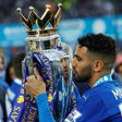 Leicester City's Algerian midfielder Riyad Mahrez poses with the Premier League trophy on May 7, 2016