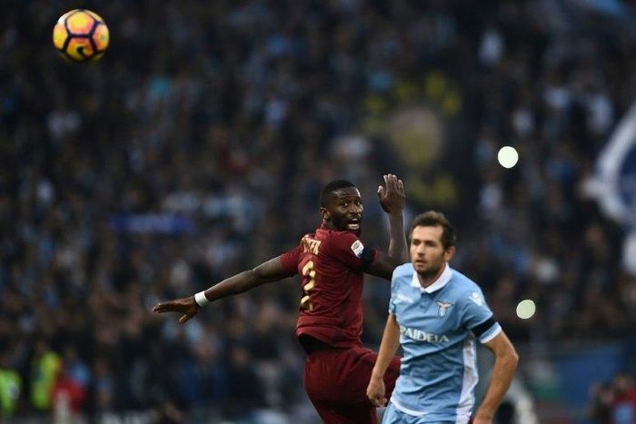 Roma's defender from Germany Antonio Rudiger (L) vies with Lazio's midfielder from Bosnia-Herzegovina Senad Lulic during the Italian Serie A football match SS Lazio vs AS Roma on December 4, 2016