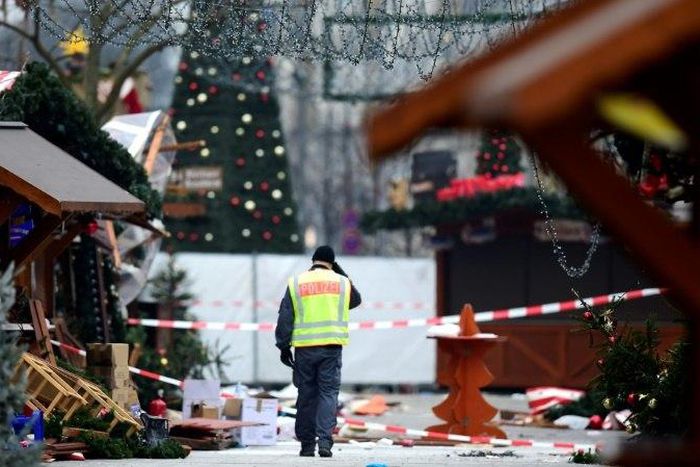 A policeman walks through the Christmas market near Berlin's Kaiser Wilhelm Memorial Church on December 20, 2016