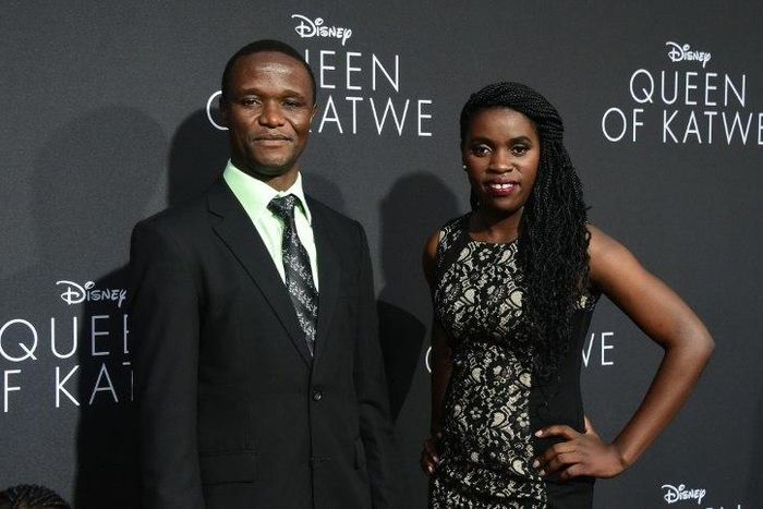 Robert Katende and Phiona Mutesi (R), whose life on which the story is based, pose on arrival for the premiere of Disney's "Queen of Katwe" in Hollywood, California on September 20, 2016