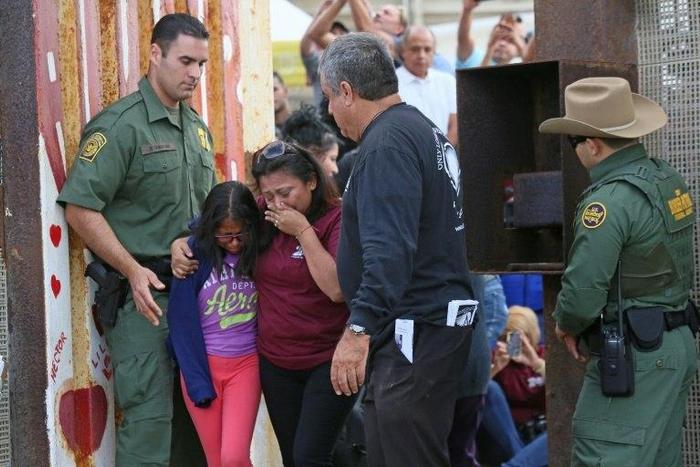 Laura Avila hugs her own daughter after getting to see her mother for three minutes at a specially organized event on the US-Mexico border