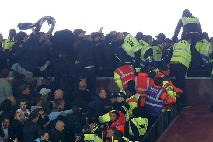 Police and stewards try to separate supporters of West Ham United and Chelsea as they confront each other during the English League Cup match at London Stadium on October 26, 2016