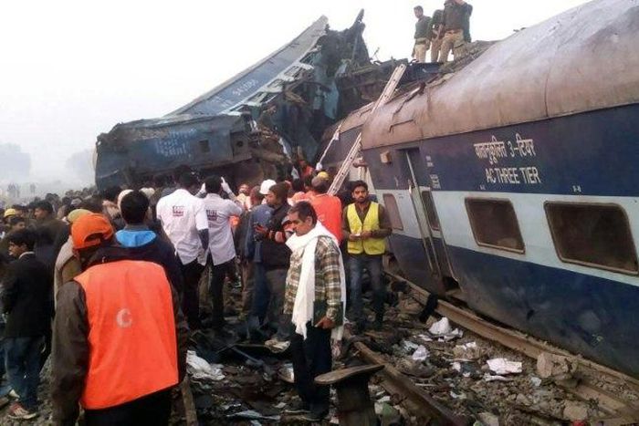 Indian rescue workers search for survivors in the wreckage of a train that derailed near Pukhrayan in Kanpur district on November 20, 2016
