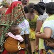 Women carry their children wait for the arrival of U.N. Secretary General Ban Ki-moon for the unveiling of a primary health care clinic in Dutse Makaranta village, on the outskirt of Nigeria's capital, Abuja May 23, 2011.