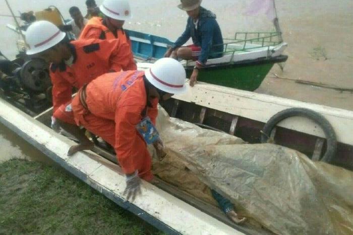 Rescue personnel transport a victim's body after an overloaded ferry sank in central Myanmar