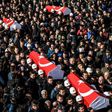 Turkish police officers carry the coffins of comrades killed in bomb attacks during a funeral cerenomy at Istanbul's police headquarters on December 11, 2016