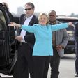 U.S. Democratic presidential candidate Clinton reacts before boarding her campaign plane at Miami international airport in Miami