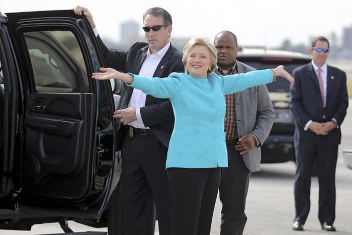 U.S. Democratic presidential candidate Clinton reacts before boarding her campaign plane at Miami international airport in Miami
