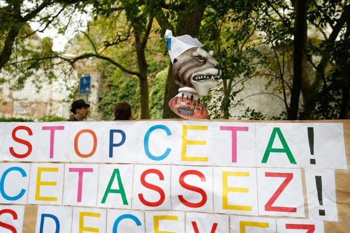A placard reads 'Stop CETA - it's enough' during a protest against the CETA trade deal in front the Walloon parliament in Namur, Belgium on October 21, 2016