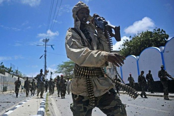 Somali security forces patrol the scene of a suicide car bomb blast in Mogadishu in August 2016