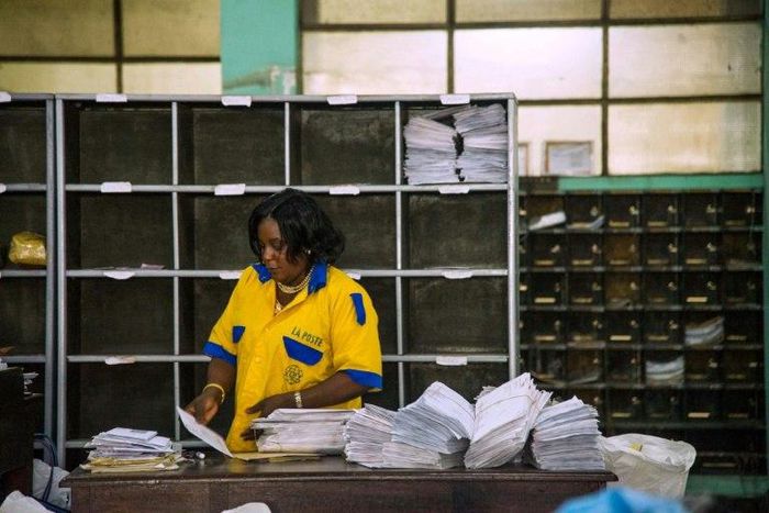 An employee distributes letters and other mail at a branch of the Congolese Company for Posts and Telecommunications in Kinshasa