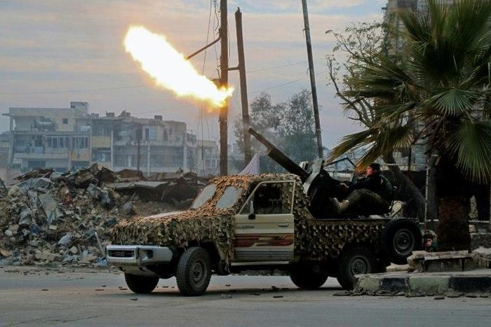 Fighters of the Free Syrian Army fire an anti-aircraft weapon in the rebel-held Mashhad area in southeastern Aleppo, on December 12, 2016