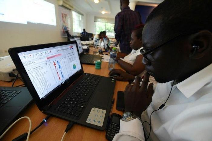 Officials of the opposition New Patriotic Party record results posted by party agents at its collection centre in Accra, on December 8, 2016