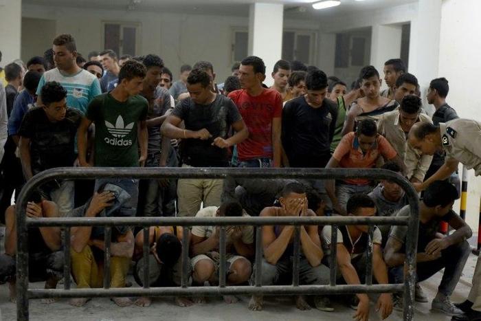 Survivors from a boat that capsized, off Egypt's north coast are seen in a police station in Rashid in northern Egypt on September 22, 2016