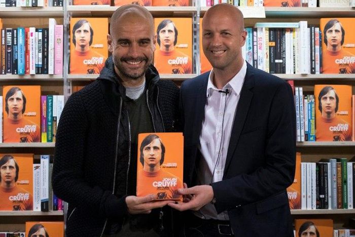 Manchester City's manager Pep Guardiola (L) poses for a photograph with former Dutch football player and manager Jordi Cruyff at an event to promote Johan Cruyff's autobiography "My Turn" in central London on October 6, 2016