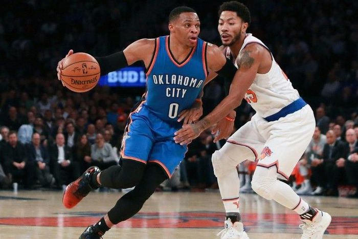 Oklahoma City Thunder's Russell Westbrook drives to the basket defended by the New York Knicks's Derrick Rose as he notches up five straight triple-doubles