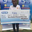Soneye Adedimeji Michael Grand Prize Winner of the Oral B National Consumer Promo, with his cheque of N300,000.