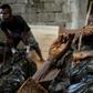 A worker arranges bodies in various stages of decomposition at the morgue of Henry's Funeral Homes in Manila