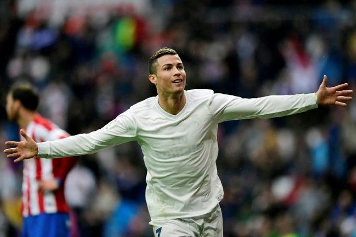 Real Madrid's Portuguese forward Cristiano Ronaldo celebrates his second goal during the Spanish league football match Real Madrid CF vs Real Sporting de Gijon at the Santiago Bernabeu stadium in Madrid on November 26, 2016