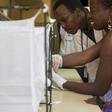A volunteer in Burkina Faso puts her arm in a box with mosquitoes to test "Faso Soap", a project to create a cheap product to repel mosquitoes and protect people from malaria