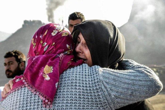 Families of trapped miners console each other at the accident site at a copper mine in Siirt, southeast Turkey on November 18, 2016