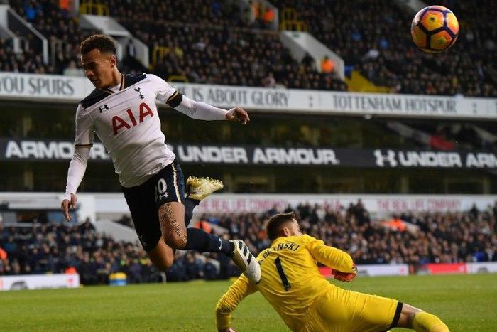 Swansea City's goalkeeper Lukasz Fabianski (R) saves a shot from Tottenham Hotspur's Dele Alli during the match on December 3, 2016